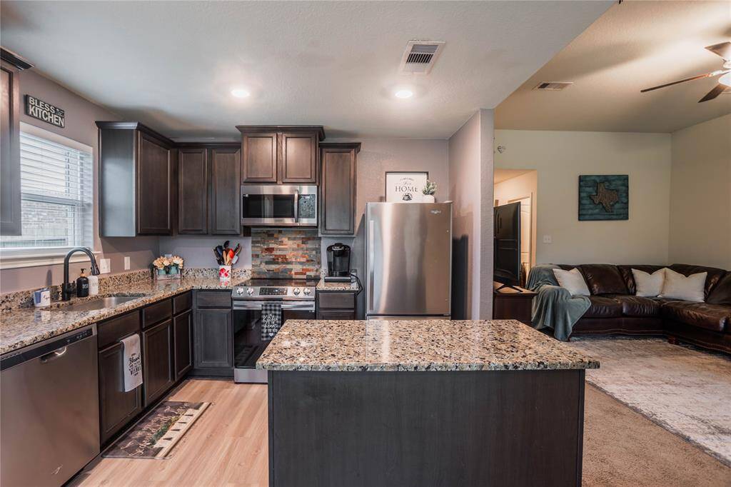 Kitchen features ample counter space and modern appliances.
