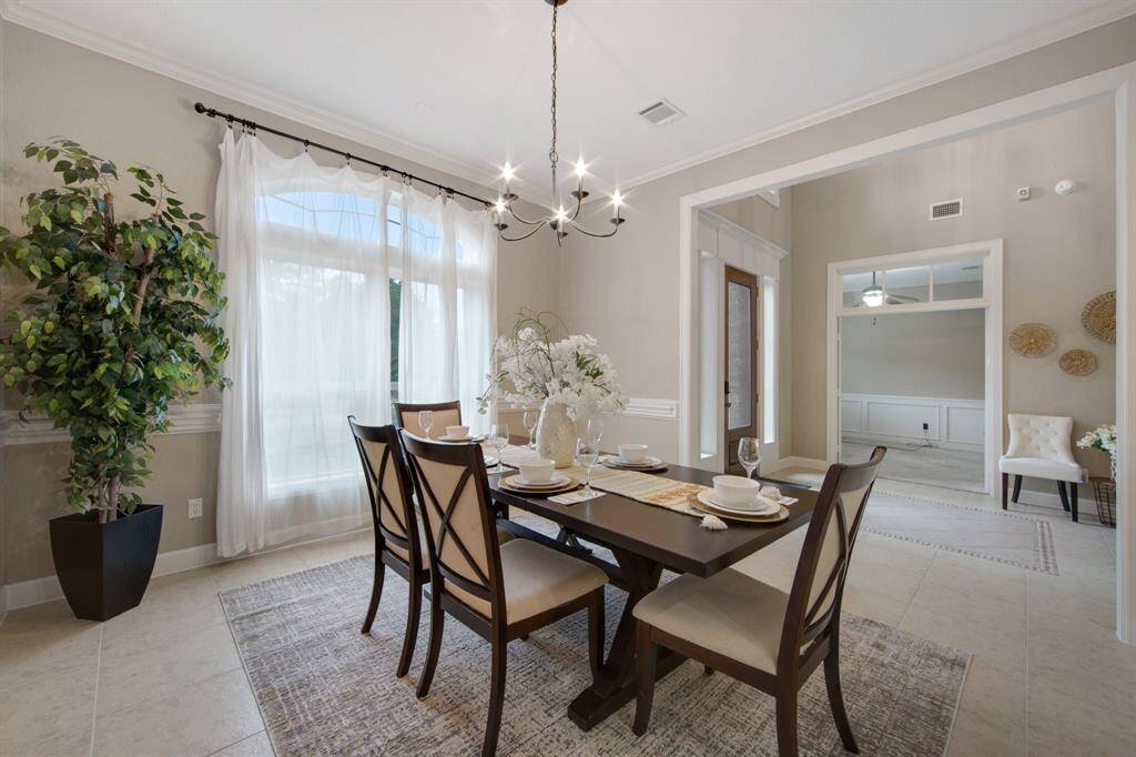 Spacious and inviting family room with abundant natural light, elegant built-in shelving, and seamless access to the outdoor patio. Perfect for gatherings and relaxation.