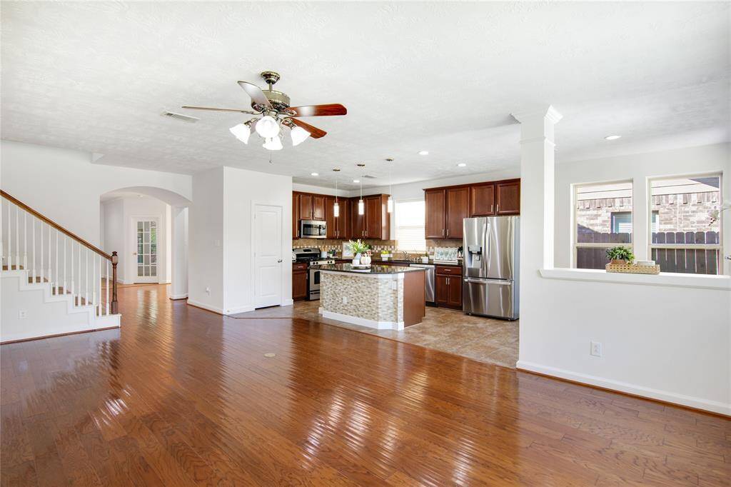 The open floor plan seamlessly connects the kitchen, dining, and living areas, creating an inviting space that's perfect for entertaining. Guests can easily mingle and enjoy the flow of conversation, making every gathering feel warm and inclusive while allowing the host to remain engaged and involved.