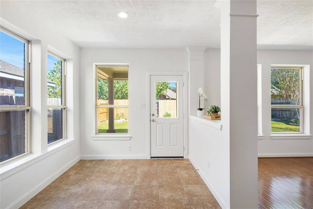 The cozy breakfast nook, bathed in natural light from nearby windows, offers a delightful space for casual meals and morning coffee. With its inviting atmosphere and charming views, it's the perfect spot to start the day or unwind with a good book.
