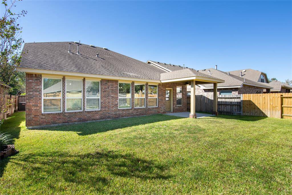The backyard is a lush oasis, featuring ample green space that beckons for outdoor adventures and serene moments alike. Imagine hosting summer barbecues on the sprawling lawn, or simply enjoying a peaceful afternoon reading beneath the shade of a tree, surrounded by the vibrant sounds of nature.