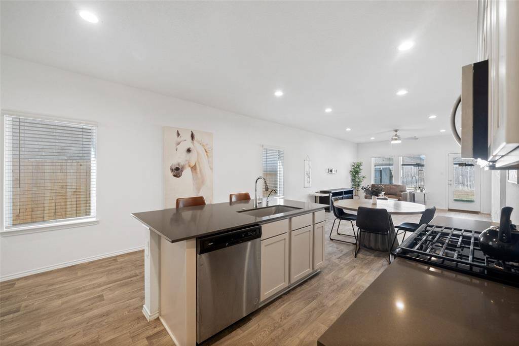Another view of the kitchen highlights its modern design, showcasing a seamless blend of style and functionality in an open and inviting space.
