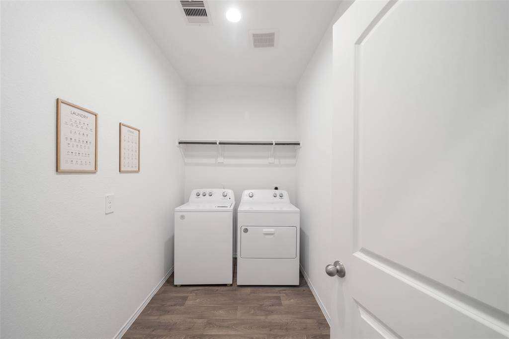 The spacious laundry room offers modern convenience with ample storage and a clean, organized feel.