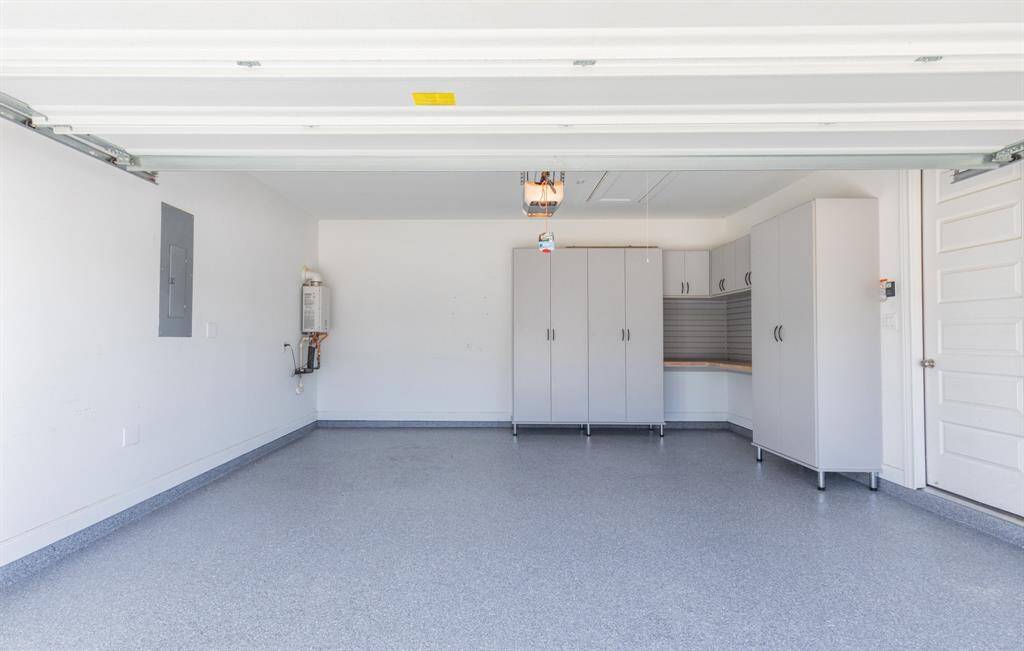 The garage floor is epoxied.   Built in Cabinets and work area.   There is also a tankless water heater for instant hot water