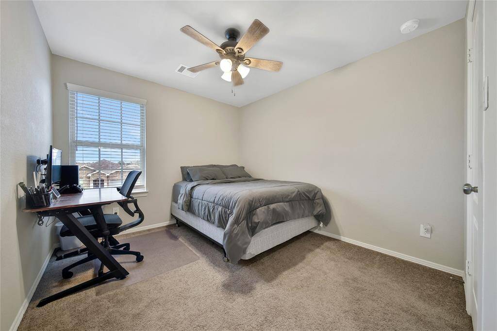 Bright and welcoming, this bedroom is perfect for kids, guests, or even a home office!