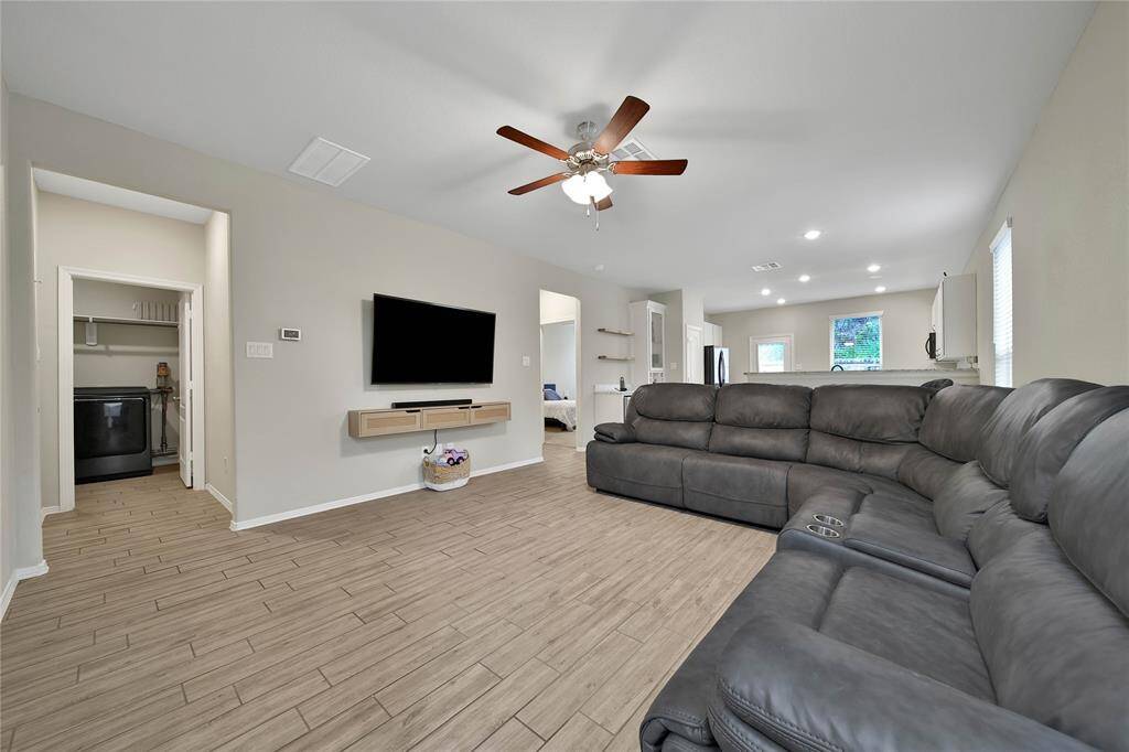 Step into this spacious living room featuring an open floor plan that is perfect for entertaining or relaxing!