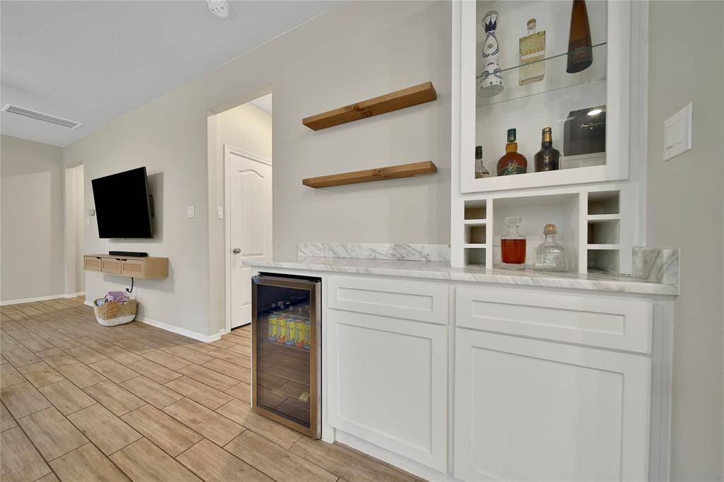 This dry bar, nestled between the kitchen and dining room, is a game-changer for your gatherings.