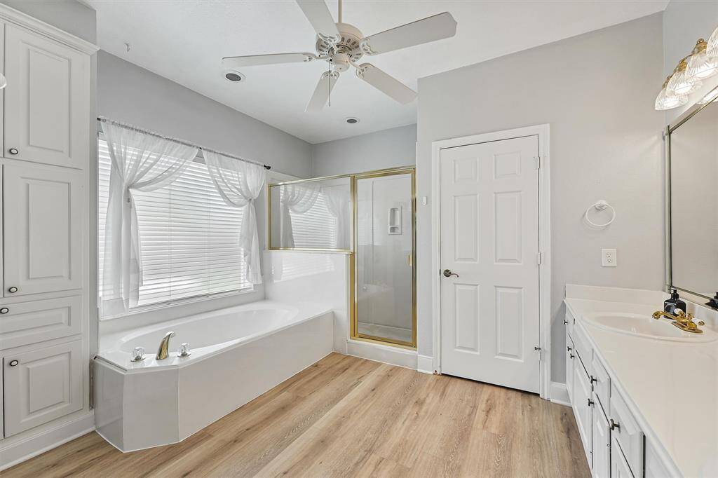 Master bath with walk-in closet and double sinks