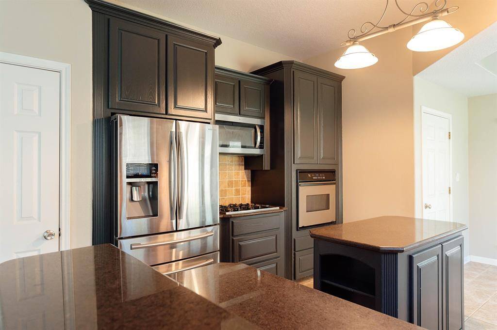 Stainless steel appliances, double-door refrigerator, mounted microwave, gas range stove, dishwasher and oven provide everything you need to make meals and memories.