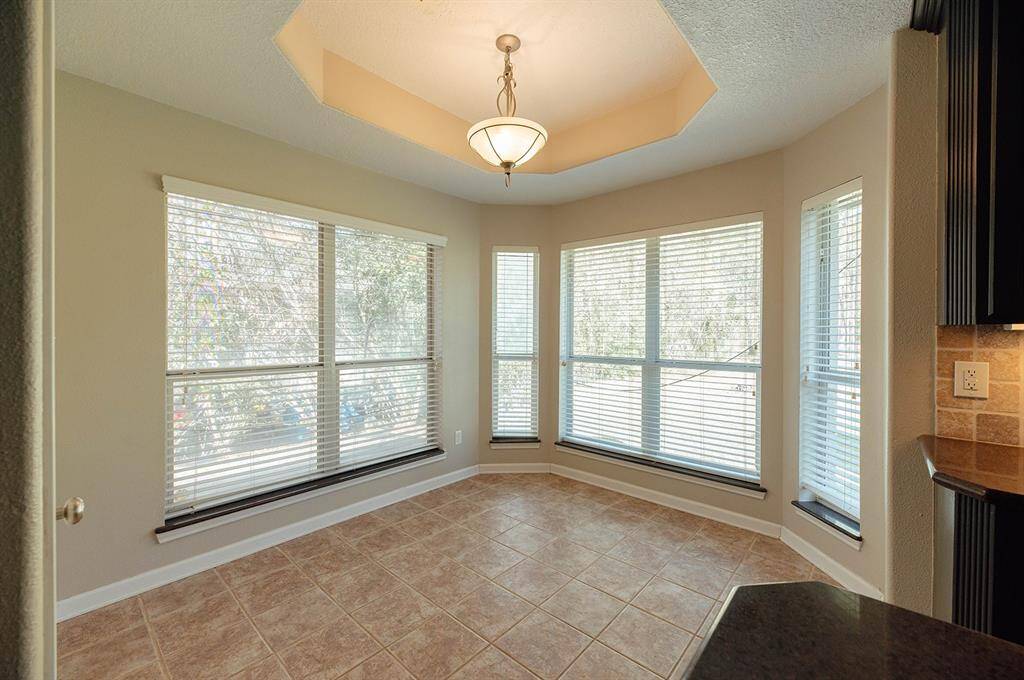 Enjoy the thoughtful features of this bright breakfast nook with wraparound windows.