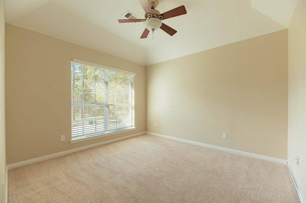 The additional bedrooms feature large windows and vaulted ceilings.