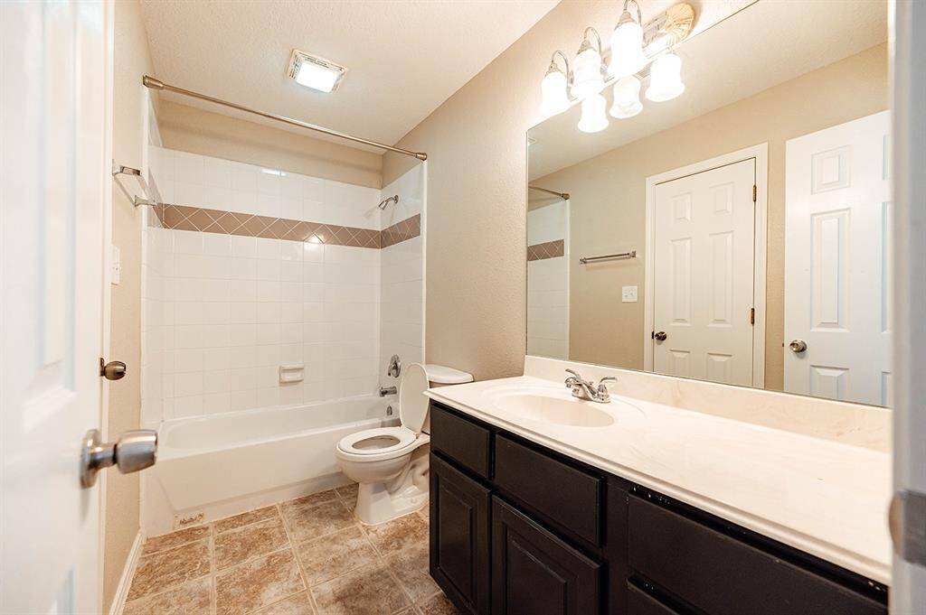 Ensuite bathroom includes shower/tub combo and spacious vanity.