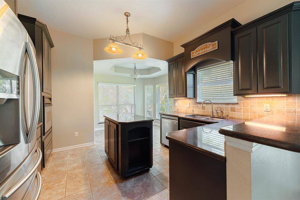 Modern kitchen featuring sleek countertops, ample cabinet space, and all the essentials for culinary creativity.