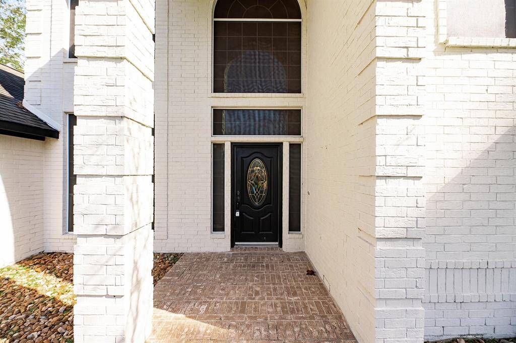 Grand windows adorn the entryway and allow for an abundance of natural light.