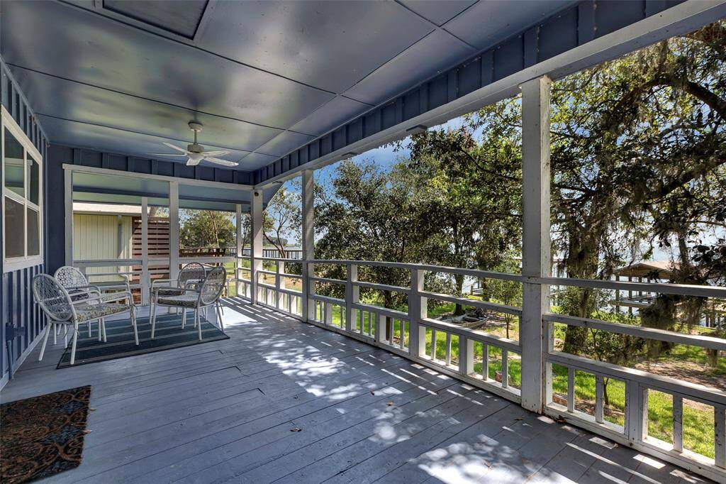 Start your day with a peaceful morning coffee or unwind in the evening with your favorite drink on the covered deck, offering breathtaking lake views and a backdrop of mature trees!