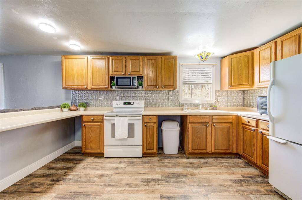 Space for dishwasher under sink where trash can is.
