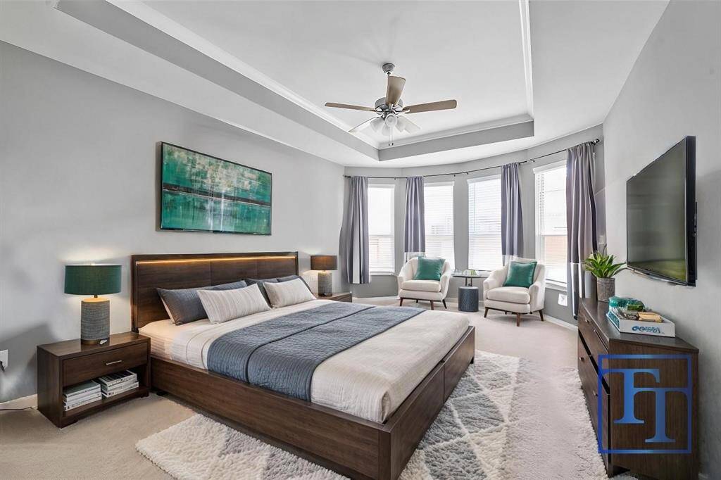 The primary bedroom features vaulted ceilings, tons of space, and plenty of natural light.