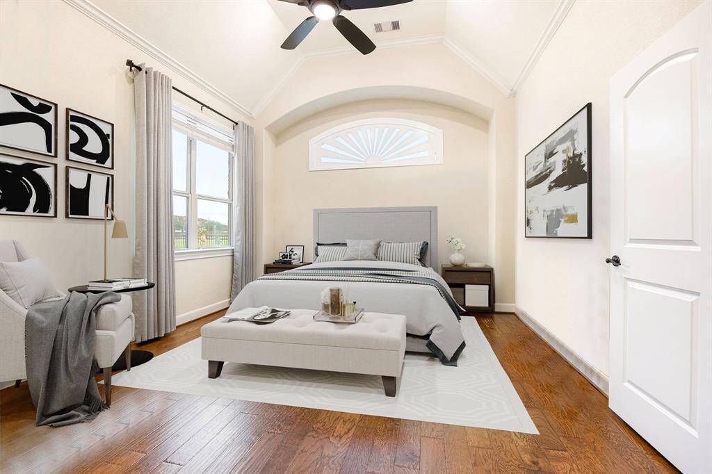 What a wonderful place to come home to! This stunning primary suite greets you with gorgeous wood floors, a warm neutral paint, high ceiling, crown molding, ceiling fan with lighting, large windows with blinds allowing in natural light brightening up this spacious primary bedroom, with extra space for a seating area. *virtually staged*