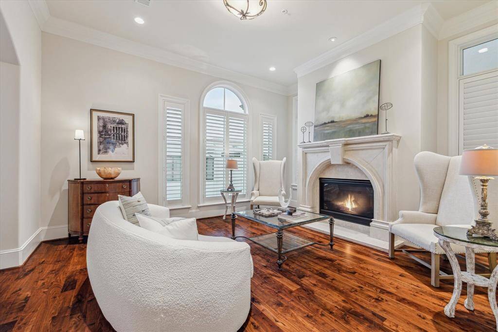 Formal living room with gaslog fireplace with cast stone hearth, surround & mantle