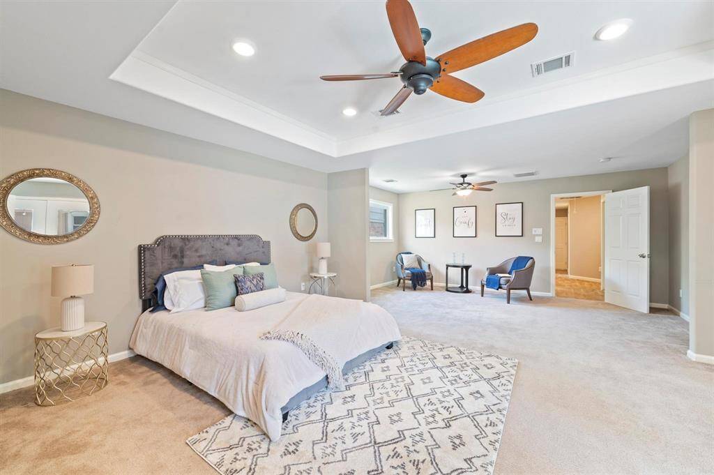 The spacious primary bedroom features a tray ceiling right over the primary space and is equipped with recessed lighting. Additionally, you'll find a private sitting area within the primary suite.