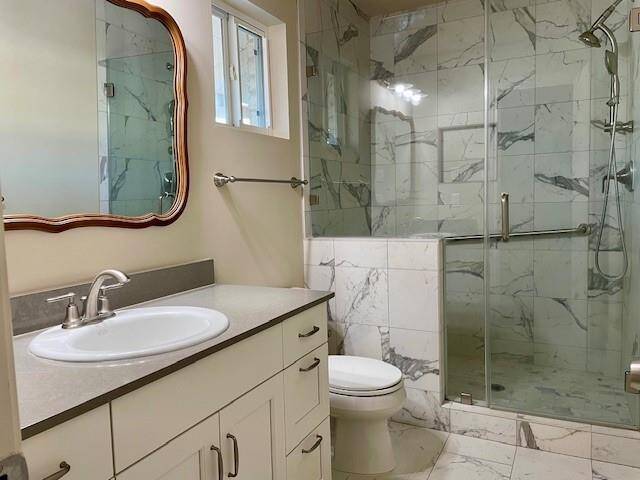 Master bath shower has a ledge for sitting or