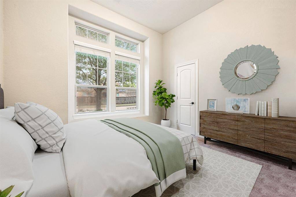 Secondary bedroom features plush carpet, neutral paint and a large window with privacy blinds. *virtually staged*