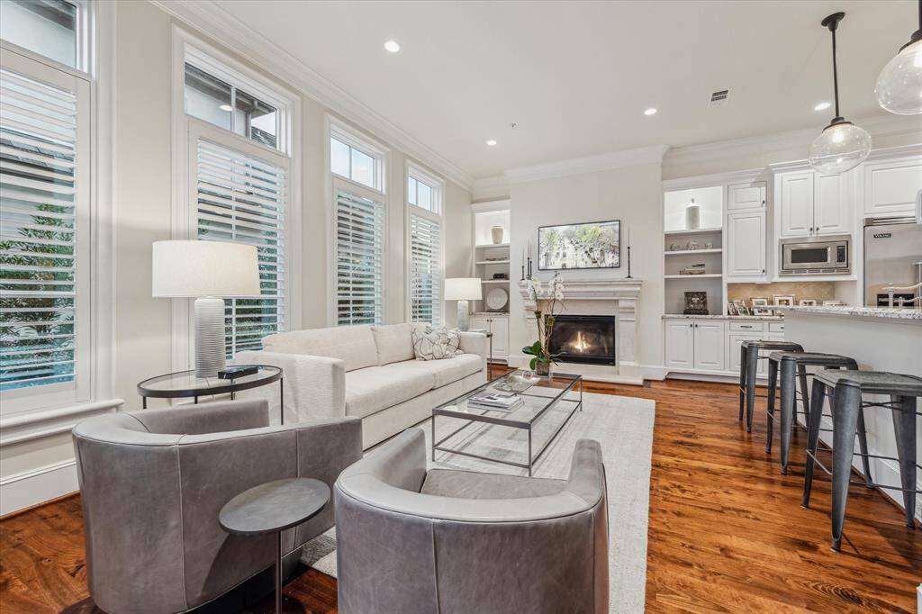 Family room with gaslog fireplace, plantation shutters & transom windows.