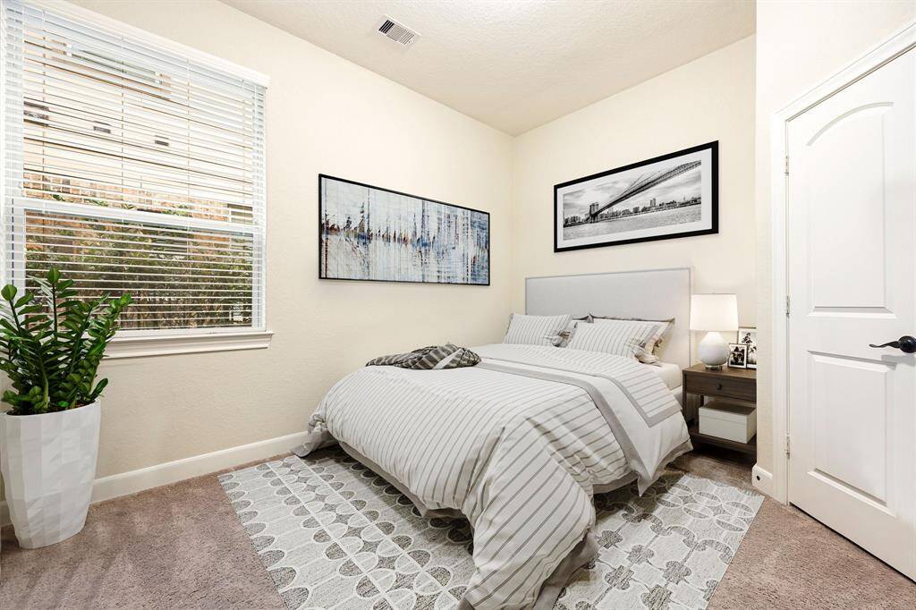 Secondary bedroom features plush carpet, neutral paint and a large window with privacy blinds. *virtually staged*