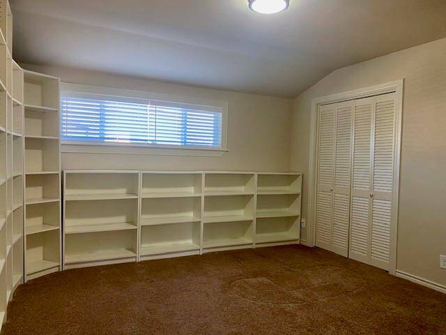 Secondary bedroom has lots of shelving.