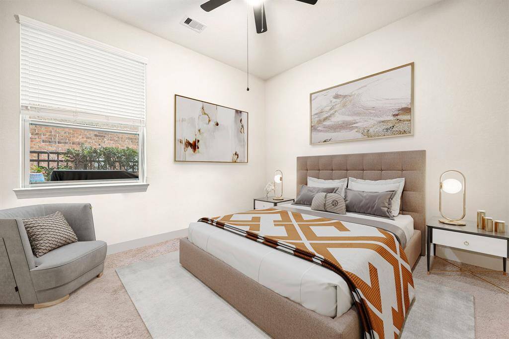 Secondary bedroom features plush carpet, neutral paint, dark stained ceiling fan with lighting and a large window with privacy blinds. *virtually staged*