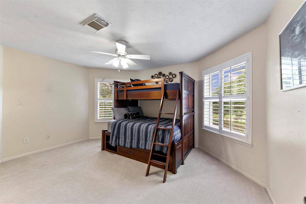 One of the four secondary bedrooms upstairs offers convenient access to a Jack and Jill bathroom, making it ideal for shared living. Its well-designed layout ensures comfort and practicality.