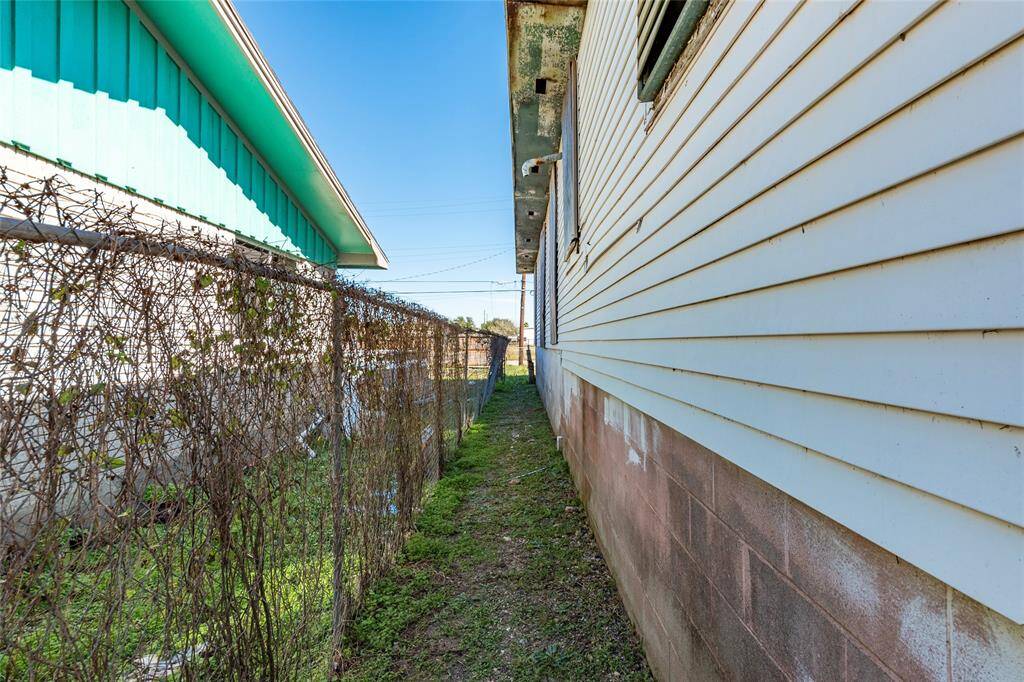 Charming side view with potential for a cozy garden or pathway, offering privacy and character.