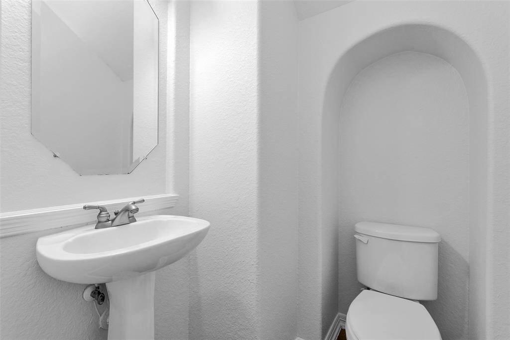 Half bath between the utility room and kitchen.
