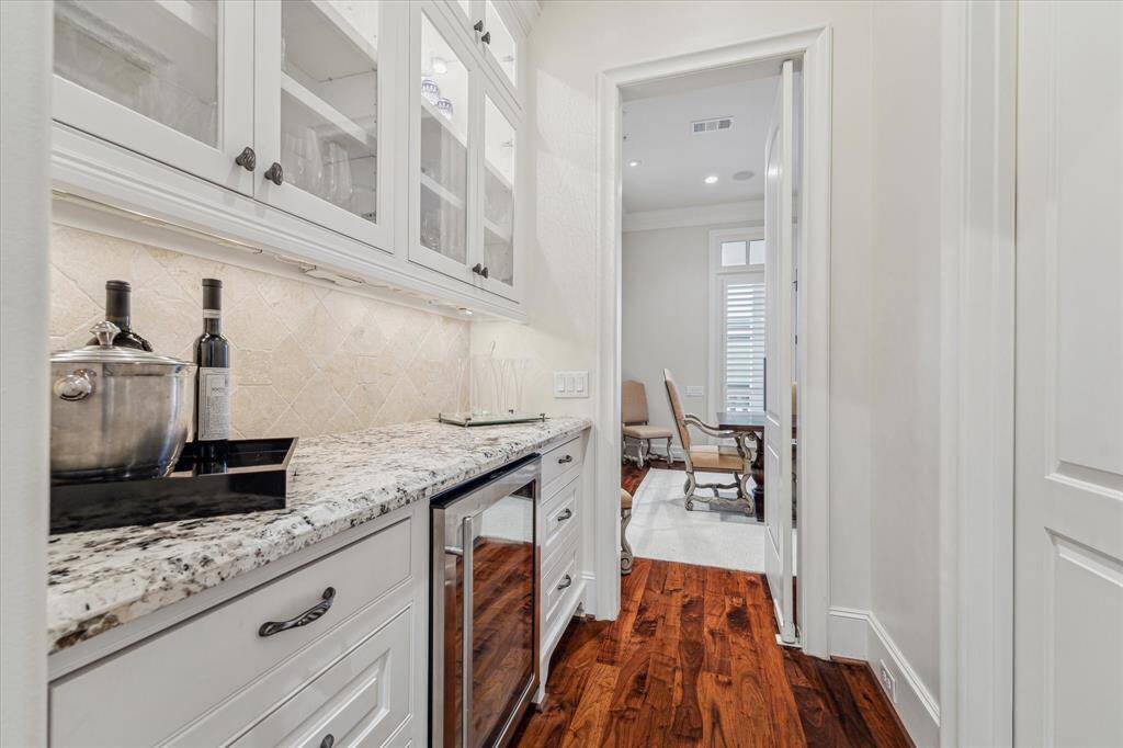 Butler's pantry with Uline wine refrigerator.  Swinging door access to dining room and door to walk in panty.