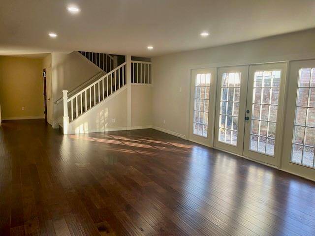 Large Den with lots of recessed light and natural light.