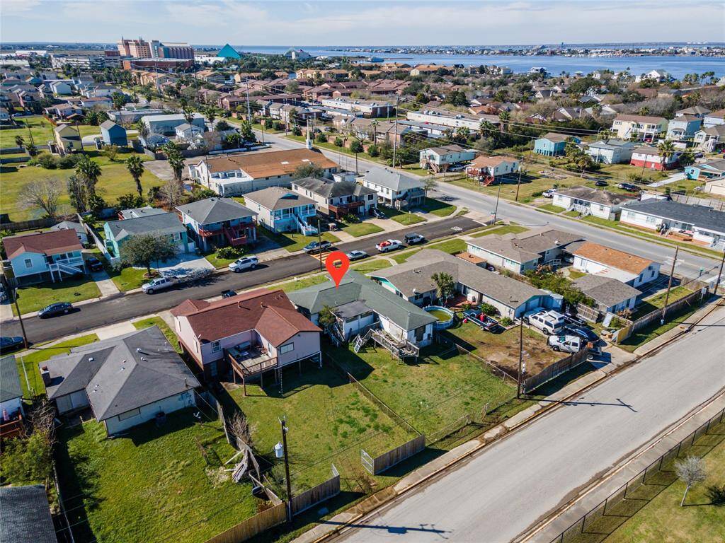 This aerial view showcases a charming residential neighborhood with single-family homes, neatly lined streets, and spacious yards. The proximity to the water hints at potential scenic views and a relaxed lifestyle.