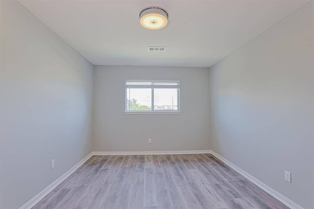 Both secondary bedrooms are bright and airy, featuring large windows and plenty of closet space.