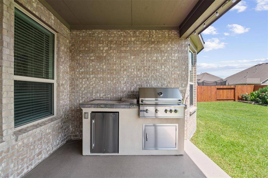 The back patio comes equipped with an outdoor kitchen area.