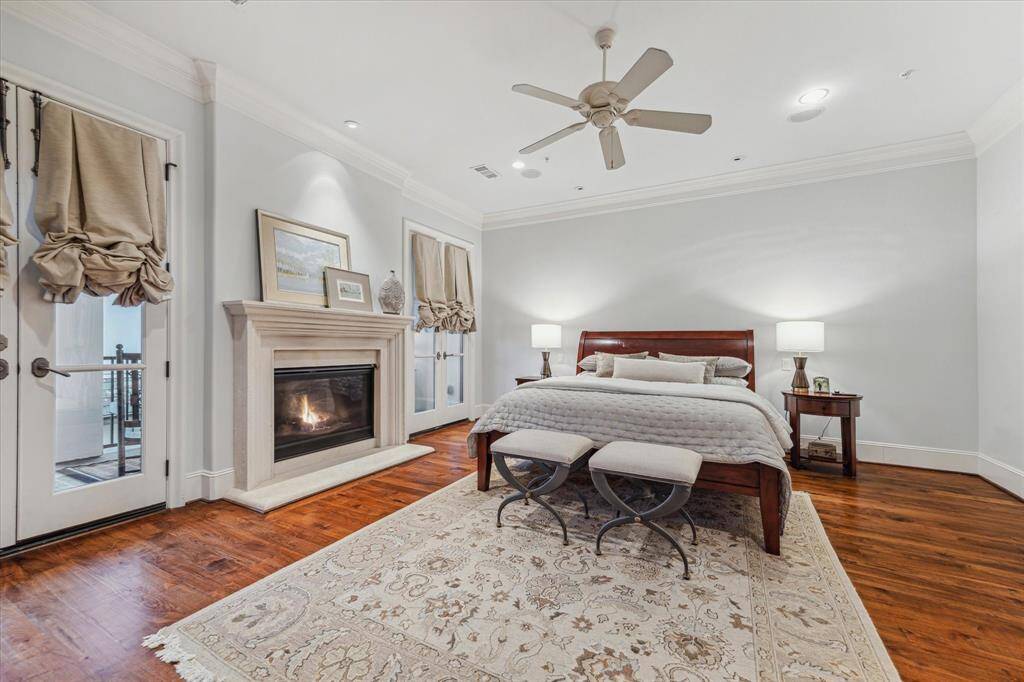 Primary Suite with gaslog fireplace, french doors to South facing patio