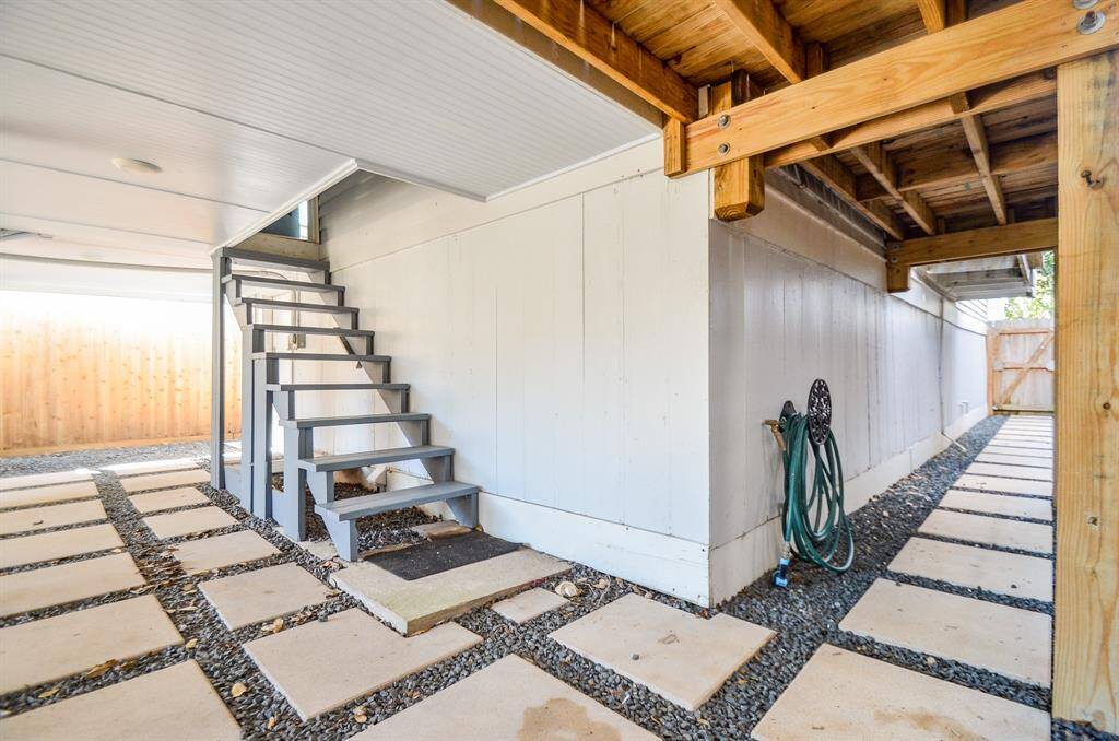 View of stairs leading from inside the house to the covered patio area. Allows covered access from inside the home to the back yard, utility room & garage.