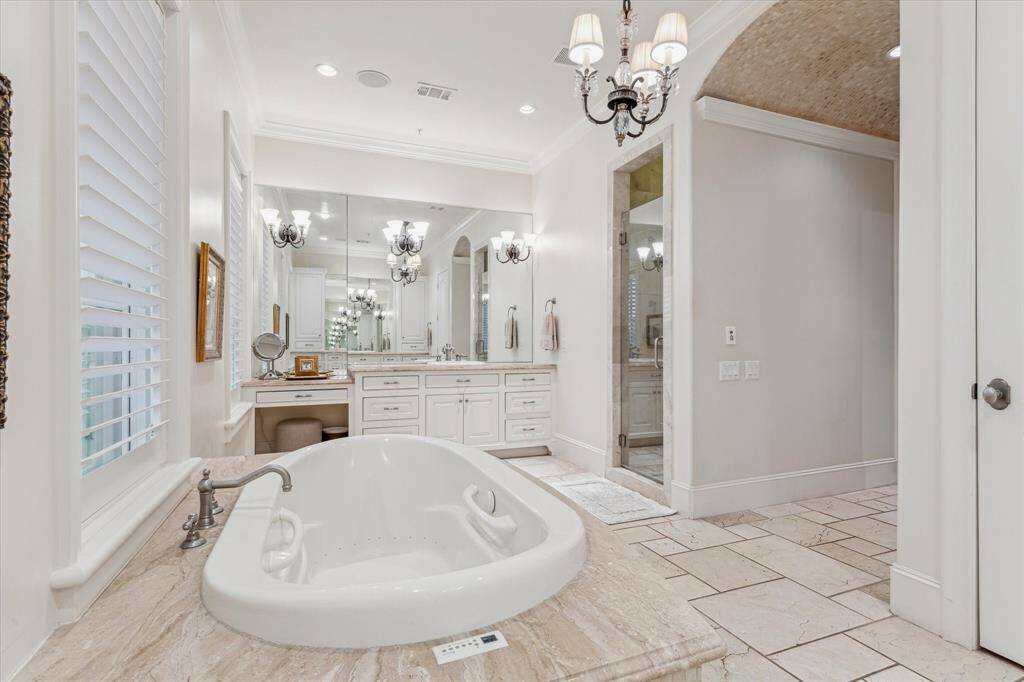 Walk in shower with bench seating and frameless door.  Private watercloset.