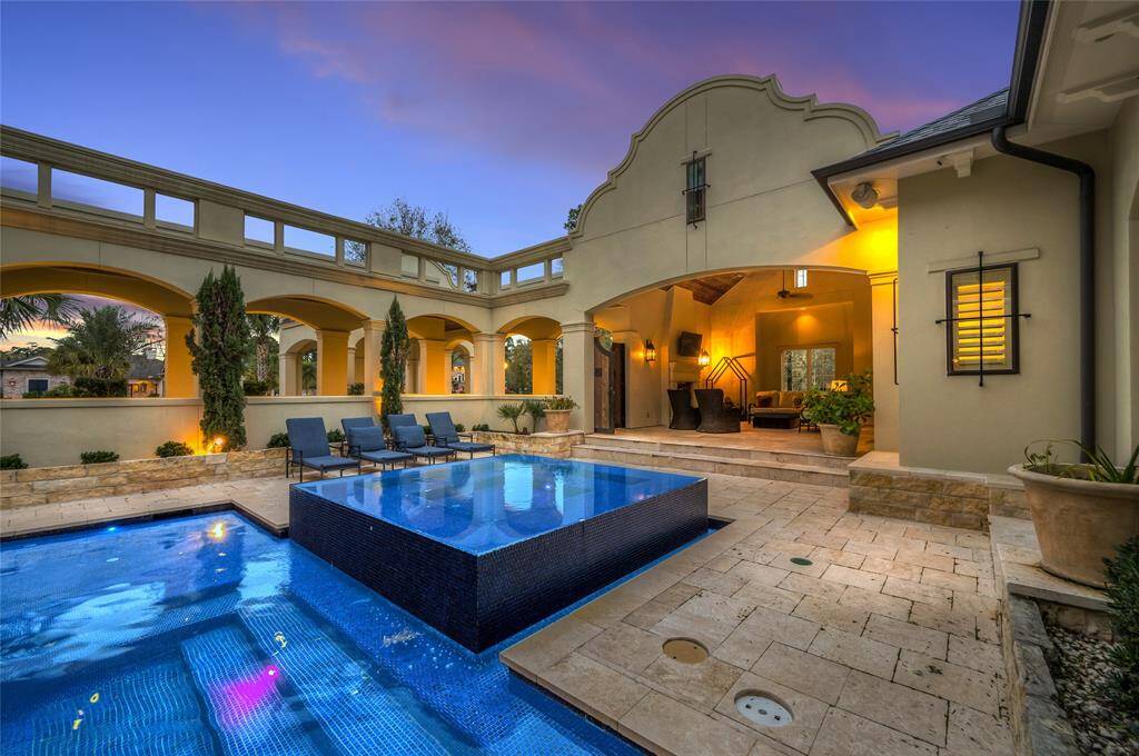 The view of the pool and elevated infinity hot tub, and the corridor that brings you into the home from the front entry or the outdoor living space.