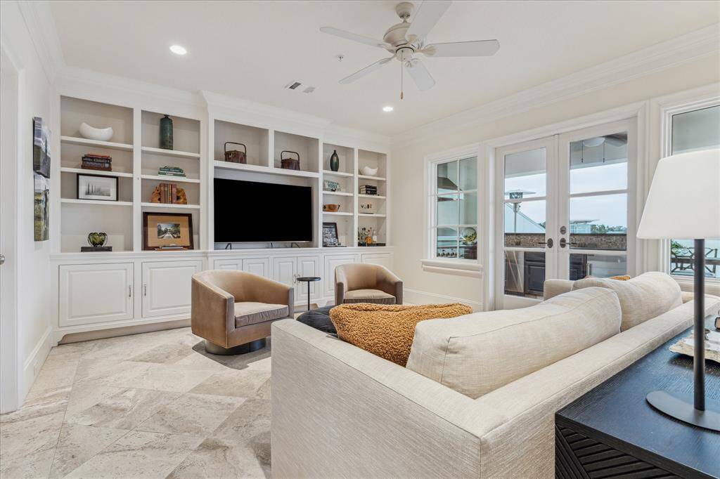 Fourth floor gameroom/3rd bedroom with built-ins and access to rooftop deck and outdoor kitchen