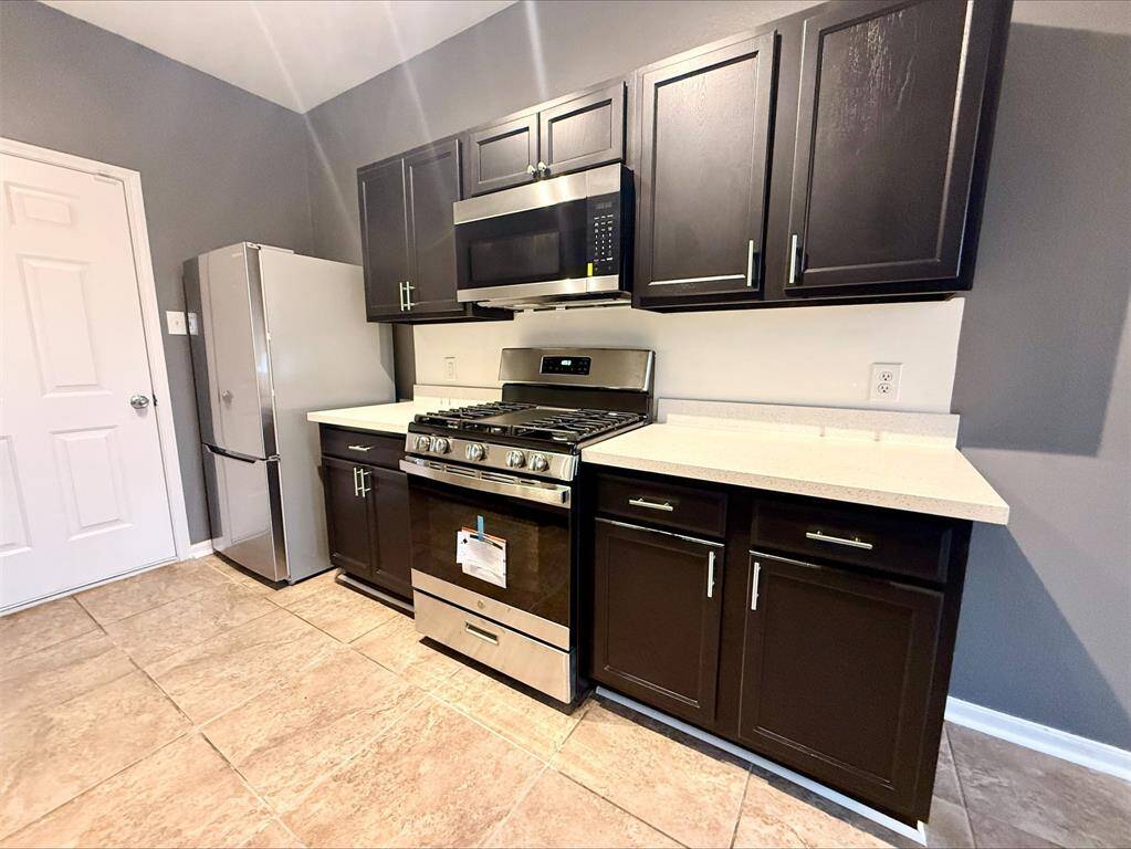 The warm tones and design create an inviting environment for cooking and gathering.
