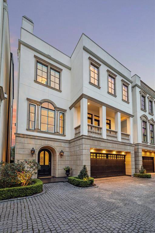 Shared cobblestone driveway with views of North facing second floor balcony.