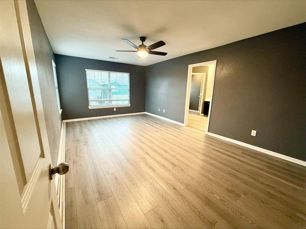 The primary bedroom is both cozy and elegant, offering plenty of space and light while maintaining a warm and welcoming vibe.