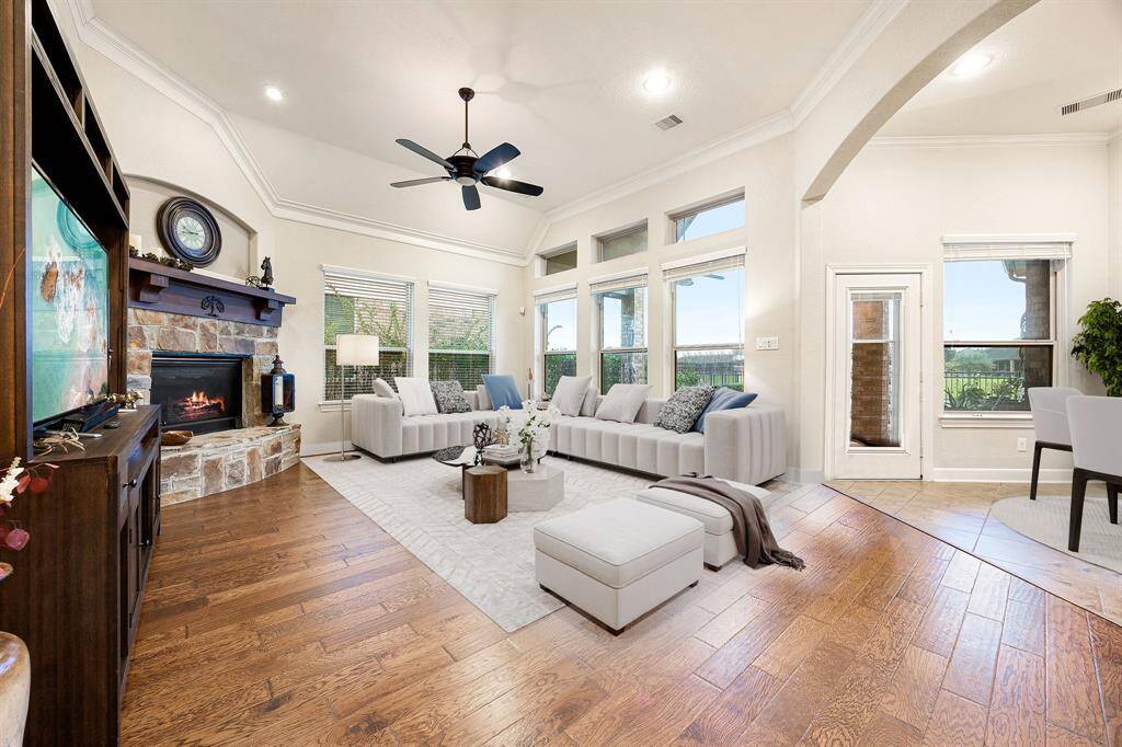Gather the family and guests together in your lovely living room! Featuring soaring high ceilings, recessed lighting, dark stained ceiling fan, neutral paint, gorgeous wood floors and large windows that provide plenty of natural lighting throughout the day. *virtually staged*
