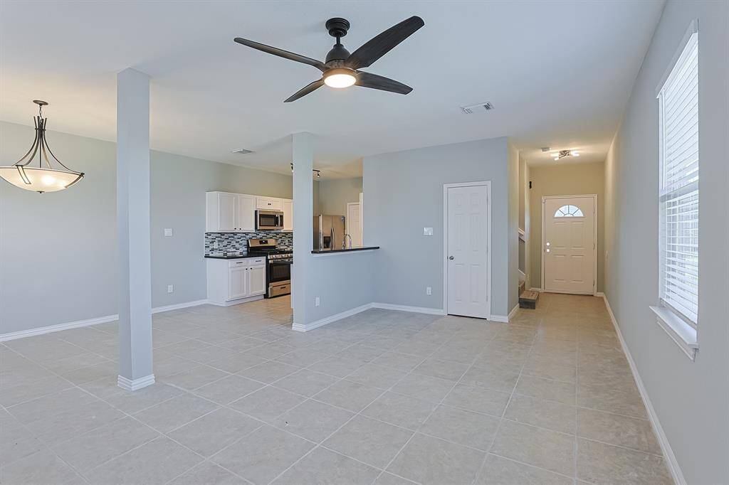 The open-concept layout seamlessly connects the living area to the kitchen and dining space, making it perfect for entertaining.