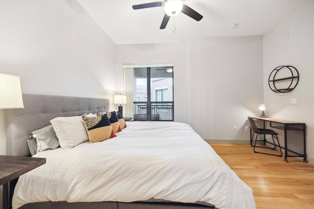 This spacious bedroom easily accommodates a king-size bed and additional furniture, offering ample room to move freely. Large windows open to the balcony, flooding the space with natural light for a bright, airy ambiance. Transform this room into your personal luxury suite.