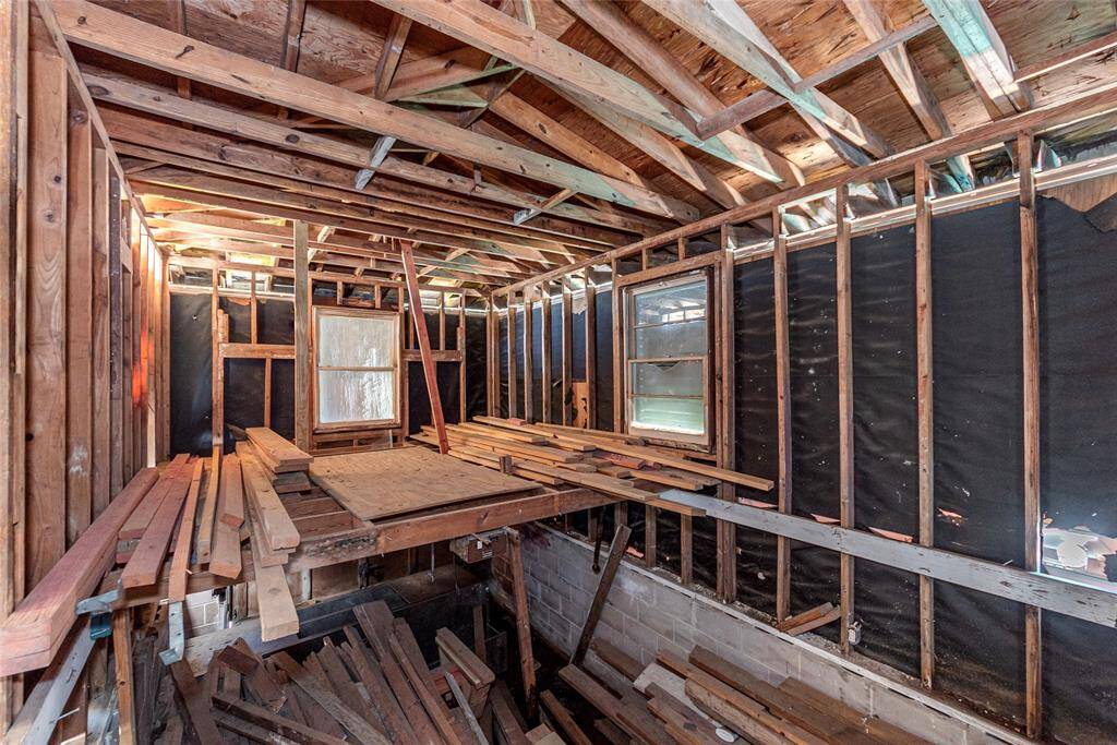 Expansive garage space ready for customization, featuring high ceilings and ample natural light. Perfect for storage or a workshop transformation.